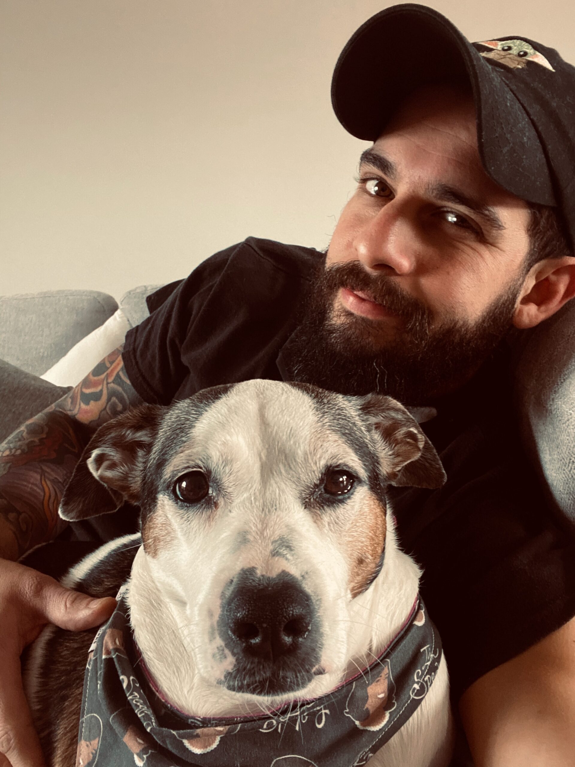 Dog Trainer Danny Alvarez from Alvarez Canine Academy with with cute dog on the couch